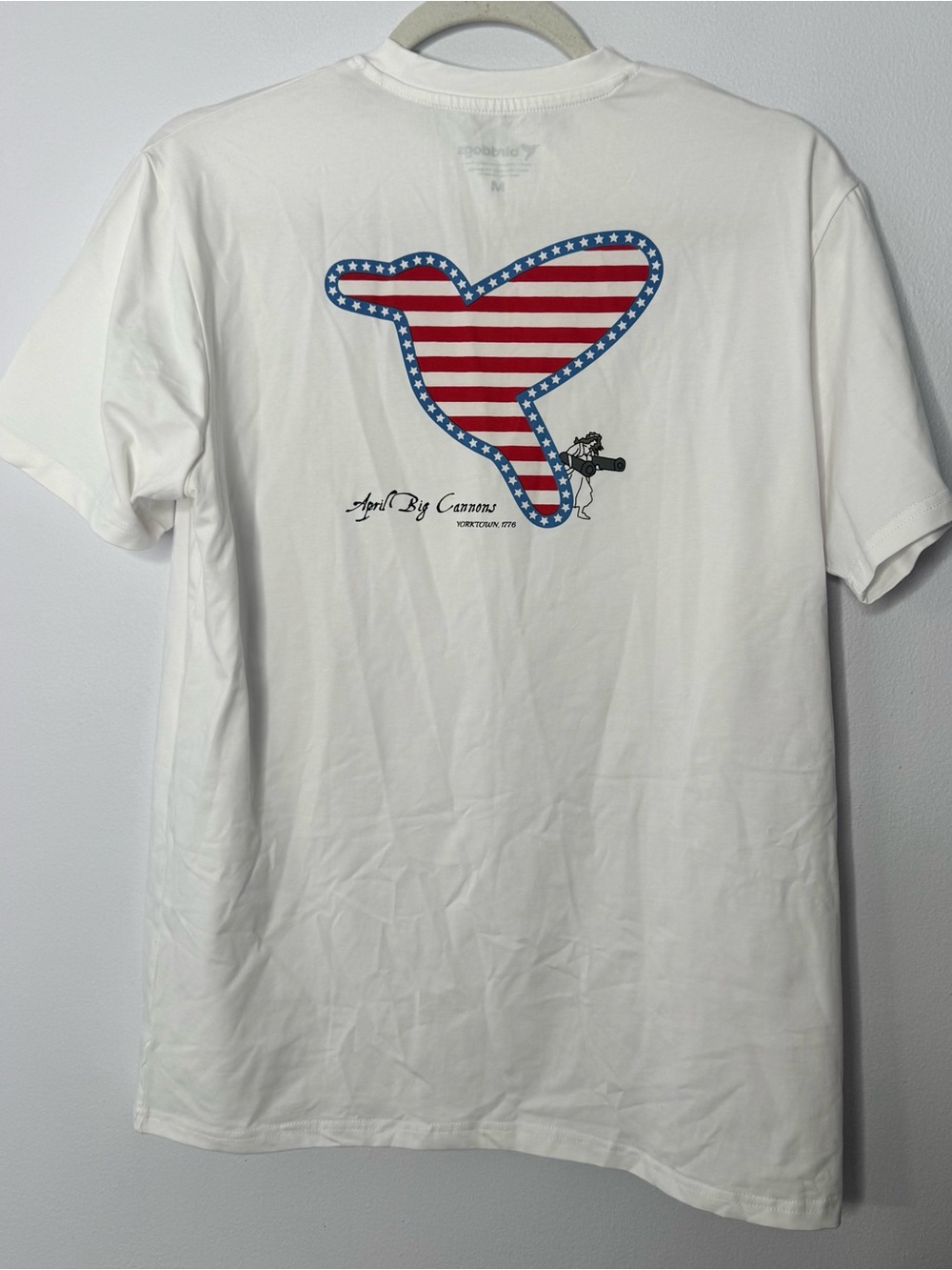 white Birddogs T-shirt featuring an "April Big Cannons